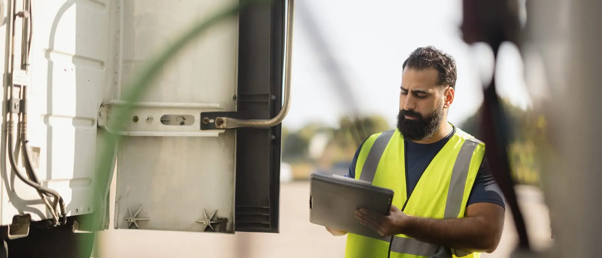 Driver completing a pre-trip inspection checklist at the vehicle